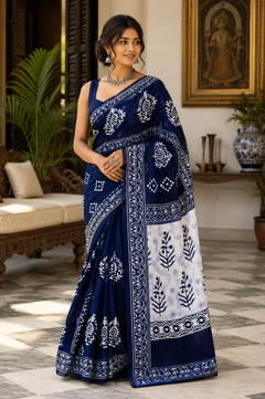 A woman modeling a navy blue and white block-printed saree.