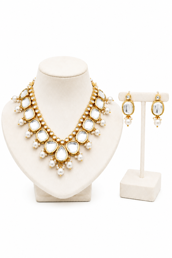 Gold statement necklace and matching drop earrings .