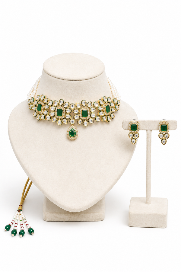 Gold and green gemstone jewelry set, including a necklace, earrings, and a dangling tassel in the back. 