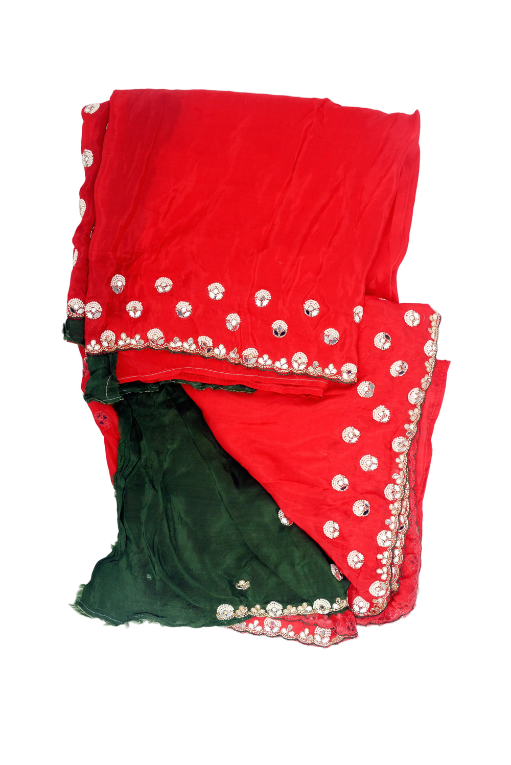 A woman modeling a red georgette saree with a dark green blouse, decorated with gold zari mirror work and embroidered borders.