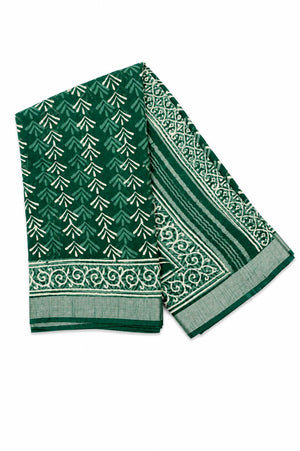 A folded green saree with white printed patterns, including a repeating chevron motif and an ornate border design.