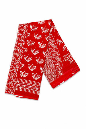 A red linen saree featuring a white hand-block printed pattern with stylized leaf motifs and geometric borders.